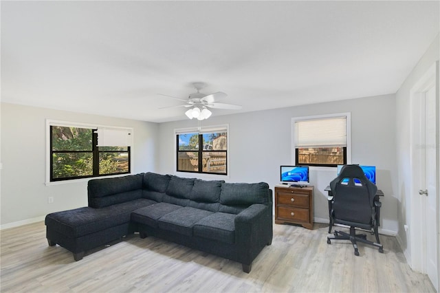 2927 Ahern Dr, Orlando, FL 32817 - living area featuring a ceiling fan, light wood-style flooring, and baseboards