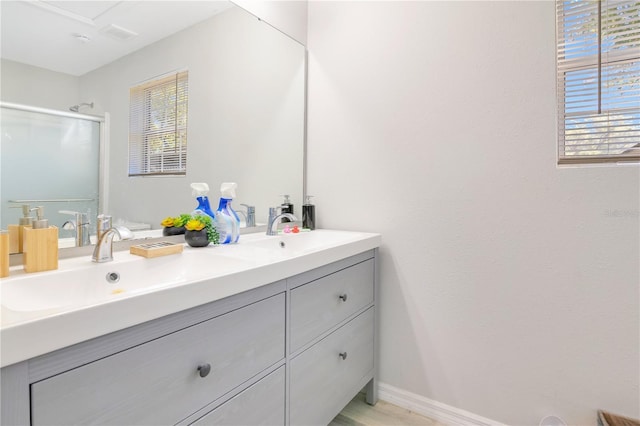 2927 Ahern Dr, Orlando, FL 32817 - bathroom featuring a stall shower, a healthy amount of sunlight, double vanity, and a sink