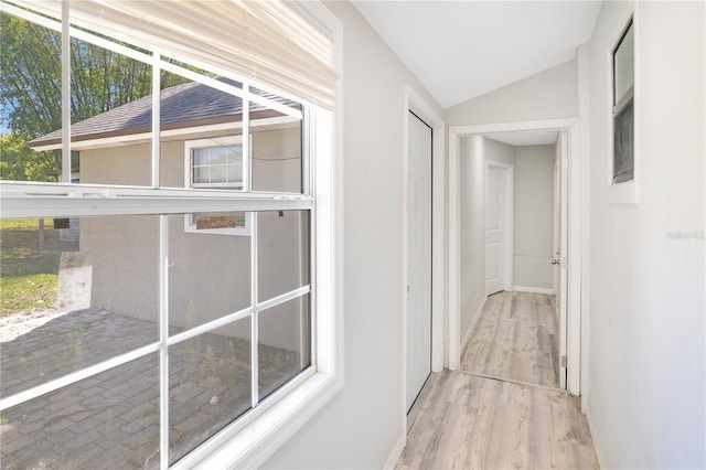 2927 Ahern Dr, Orlando, FL 32817 - hall featuring baseboards, vaulted ceiling, and wood finished floors