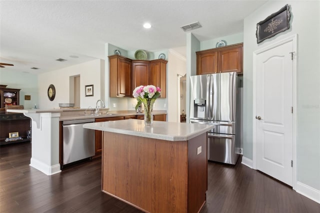 2842 Balforn Tower, Winter Garden, FL 34787 - kitchen with a sink, a peninsula, stainless steel appliances, visible vents, and light countertops