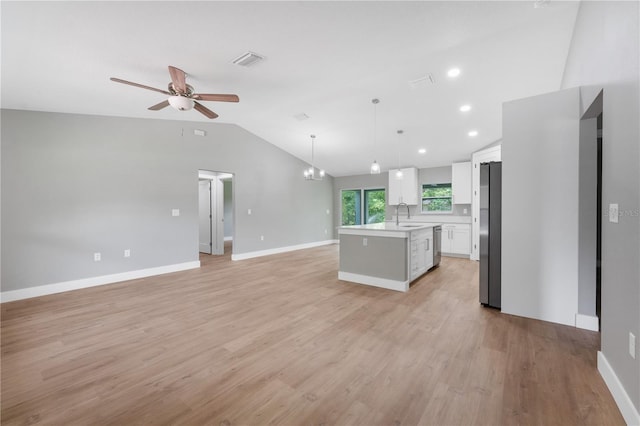 274 W Bolero Pl, Citrus Springs, FL 34434 - unfurnished living room featuring a ceiling fan, lofted ceiling, a chandelier, a sink, and light wood-type flooring