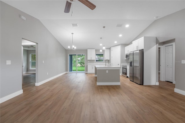 274 W Bolero Pl, Citrus Springs, FL 34434 - kitchen featuring appliances with stainless steel finishes, vaulted ceiling, a sink, open floor plan, and light countertops