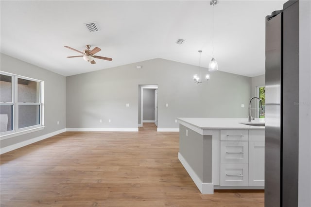 274 W Bolero Pl, Citrus Springs, FL 34434 - kitchen featuring a sink, ceiling fan, vaulted ceiling, light countertops, and white cabinets