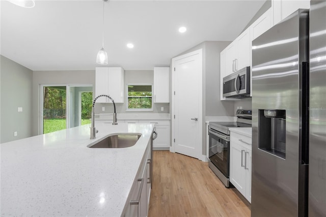 274 W Bolero Pl, Citrus Springs, FL 34434 - kitchen with appliances with stainless steel finishes, a sink, recessed lighting, white cabinetry, and hanging light fixtures