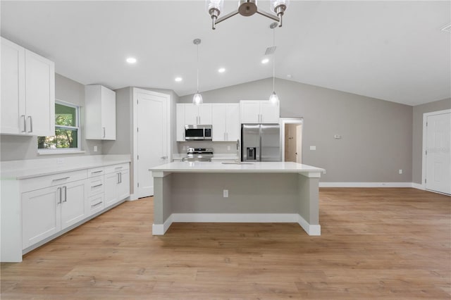 274 W Bolero Pl, Citrus Springs, FL 34434 - kitchen with stainless steel appliances, white cabinetry, light countertops, a center island, and vaulted ceiling