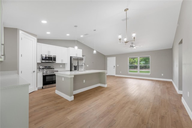 274 W Bolero Pl, Citrus Springs, FL 34434 - kitchen featuring stainless steel appliances, lofted ceiling, a chandelier, light countertops, and white cabinetry