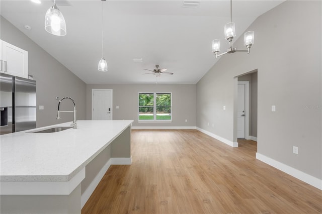 274 W Bolero Pl, Citrus Springs, FL 34434 - kitchen with stainless steel refrigerator with ice dispenser, a sink, vaulted ceiling, ceiling fan, and light wood-style floors