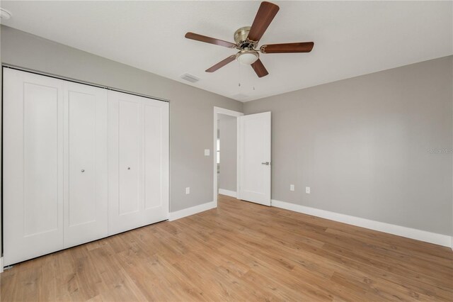 274 W Bolero Pl, Citrus Springs, FL 34434 - unfurnished bedroom with baseboards, light wood-type flooring, a closet, and ceiling fan