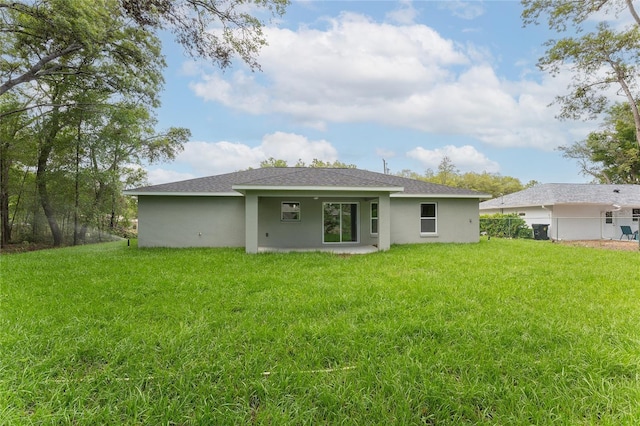 274 W Bolero Pl, Citrus Springs, FL 34434 - rear view of house featuring stucco siding, a yard, and a shingled roof