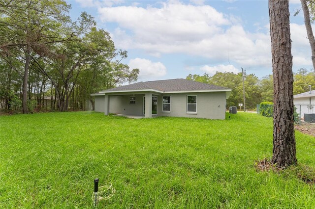 274 W Bolero Pl, Citrus Springs, FL 34434 - rear view of house featuring stucco siding, central AC, and a shingled roof