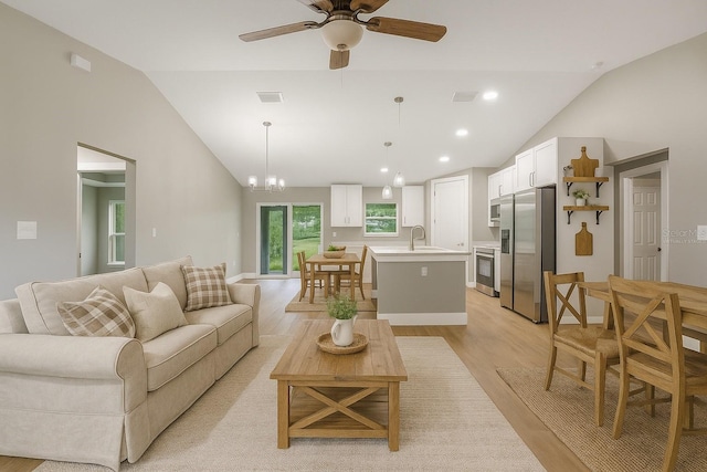 274 W Bolero Pl, Citrus Springs, FL 34434 - living room with vaulted ceiling, light wood-type flooring, a ceiling fan, a chandelier, and recessed lighting