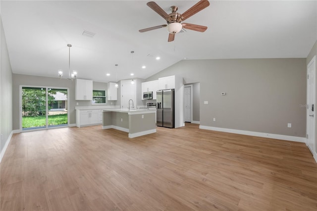 274 W Bolero Pl, Citrus Springs, FL 34434 - unfurnished living room featuring lofted ceiling, ceiling fan, light wood-style floors, recessed lighting, and a chandelier