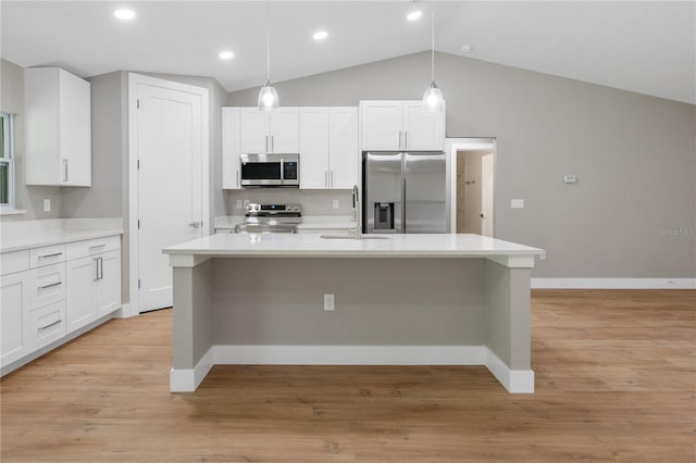 274 W Bolero Pl, Citrus Springs, FL 34434 - kitchen with appliances with stainless steel finishes, white cabinetry, a kitchen island with sink, vaulted ceiling, and light countertops