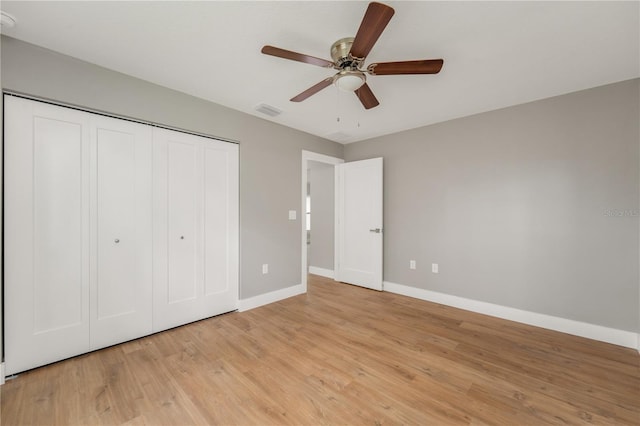 274 W Bolero Pl, Citrus Springs, FL 34434 - unfurnished bedroom with light wood-style floors, a closet, and a ceiling fan