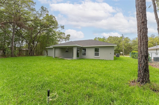 274 W Bolero Pl, Citrus Springs, FL 34434 - rear view of house with stucco siding and roof with shingles