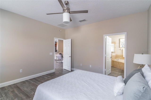 bedroom with ensuite bath, a textured ceiling, visible vents, and dark wood-style floors