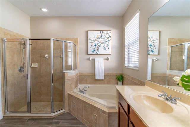 bathroom featuring a shower stall, a bath, and plenty of natural light