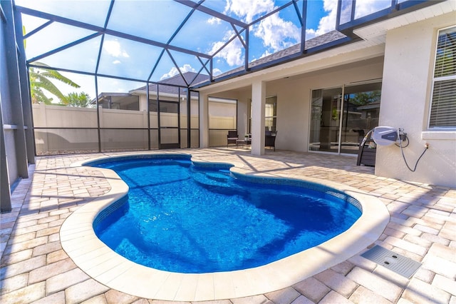 view of pool featuring a patio area, a fenced in pool, a lanai, and fence