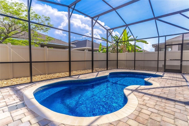 view of pool featuring a fenced backyard, a patio area, a fenced in pool, and a lanai