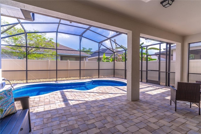view of swimming pool with a patio area, a fenced in pool, a lanai, and fence