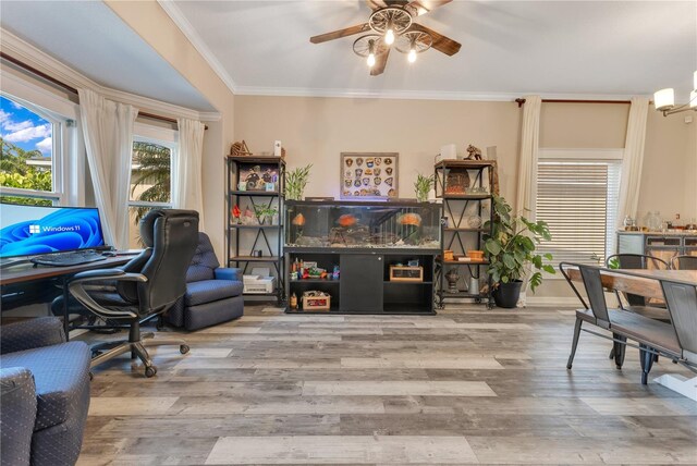 home office with ornamental molding, baseboards, a ceiling fan, and wood finished floors