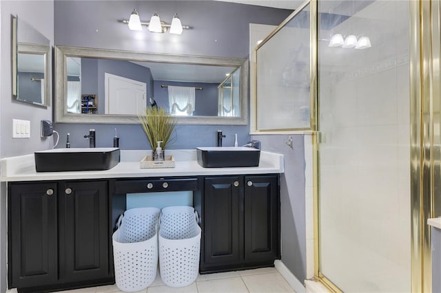 bathroom featuring a shower stall, tile patterned floors, and a sink