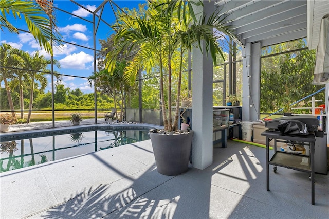 outdoor pool with a patio and glass enclosure