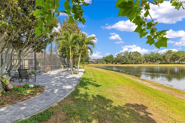 surrounding community featuring a yard, a water view, and a patio