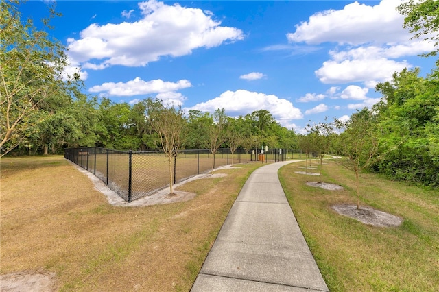 view of home's community featuring a yard and fence