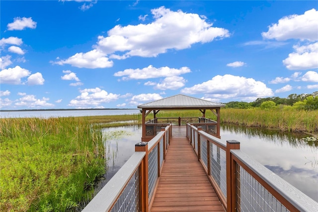 view of dock featuring a gazebo and a water view