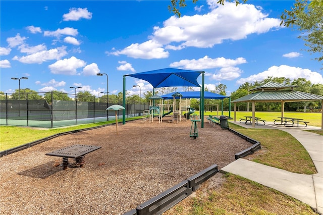 community jungle gym with a yard, fence, a gazebo, and a tennis court
