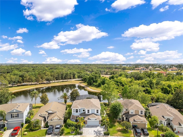 bird's eye view featuring a water view, a wooded view, and a residential view