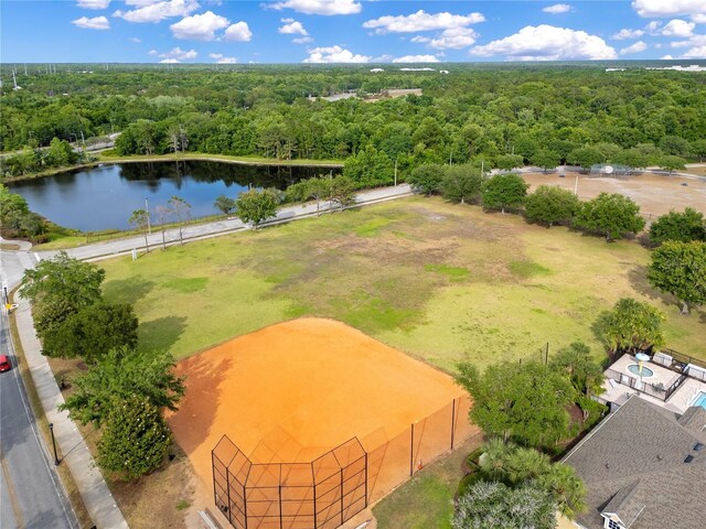 drone / aerial view featuring a water view and a forest view