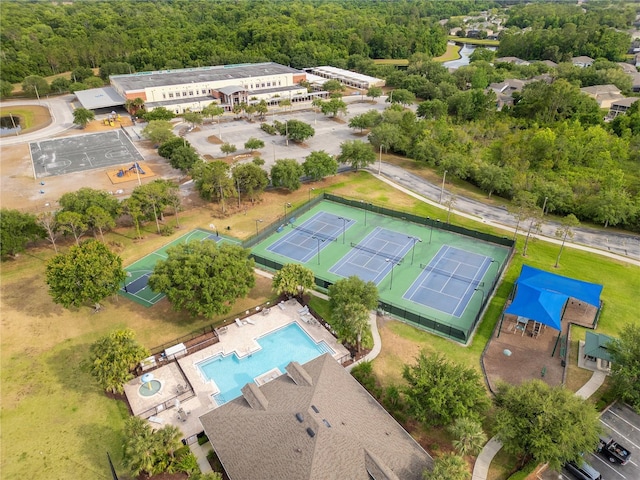 bird's eye view with a wooded view