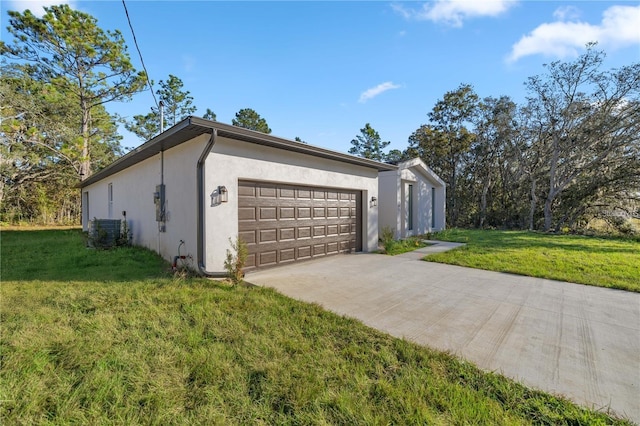 view of side of home featuring a yard, driveway, an attached garage, central air condition unit, and stucco siding