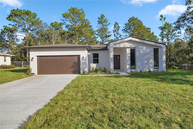 view of front of property with a front yard, concrete driveway, stucco siding, and a garage