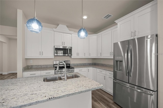 kitchen with white cabinets, dark wood-style floors, and appliances with stainless steel finishes
