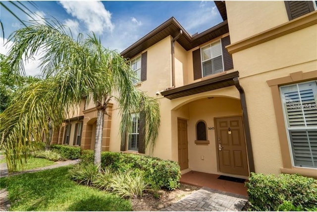 3643 Calabria Ave, Davenport, FL 33897 - property entrance with stucco siding