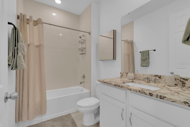 bathroom featuring toilet, shower / bath combo, and vanity