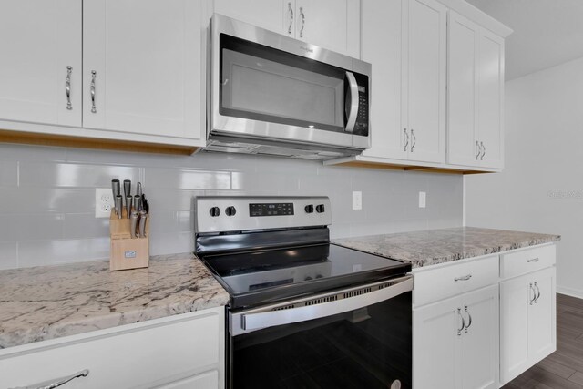 3017 Ambersweet Pl, Clermont, FL 34711 - kitchen with appliances with stainless steel finishes, decorative backsplash, white cabinetry, and light stone counters