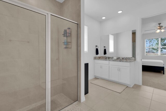 3017 Ambersweet Pl, Clermont, FL 34711 - bathroom with a stall shower, a ceiling fan, tile patterned floors, connected bathroom, and vanity