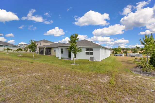 3017 Ambersweet Pl, Clermont, FL 34711 - back of property with cooling unit, a lawn, and stucco siding
