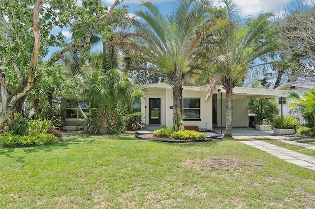 318 E Jersey St, Orlando, FL 32806 - view of front facade with a front lawn, driveway, and an attached carport