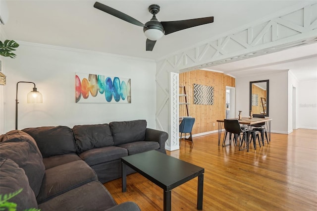 318 E Jersey St, Orlando, FL 32806 - living area featuring ornamental molding, ceiling fan, wood finished floors, baseboards, and wood walls