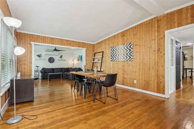 318 E Jersey St, Orlando, FL 32806 - dining room featuring wooden walls, ornamental molding, wood finished floors, ceiling fan, and an AC wall unit