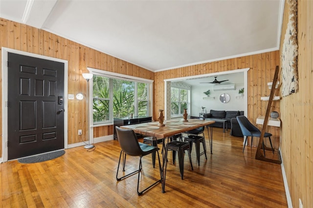 318 E Jersey St, Orlando, FL 32806 - dining space featuring a wall mounted air conditioner, wooden walls, wood finished floors, crown molding, and a ceiling fan