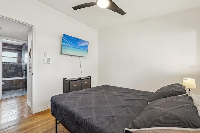 318 E Jersey St, Orlando, FL 32806 - bedroom with light wood-style floors, ceiling fan, and baseboards