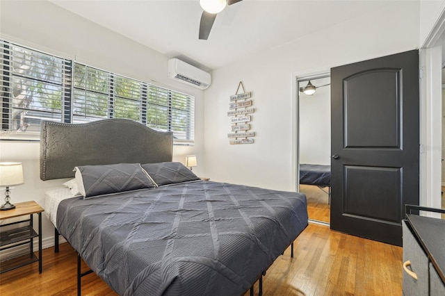 318 E Jersey St, Orlando, FL 32806 - bedroom featuring an AC wall unit, wood finished floors, and ceiling fan