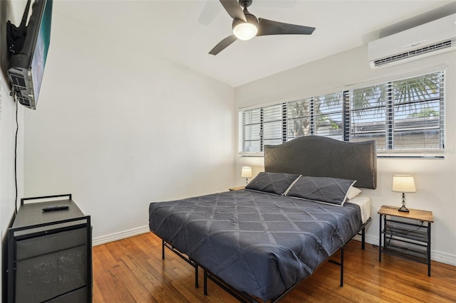318 E Jersey St, Orlando, FL 32806 - bedroom featuring a wall unit AC, wood finished floors, baseboards, and ceiling fan