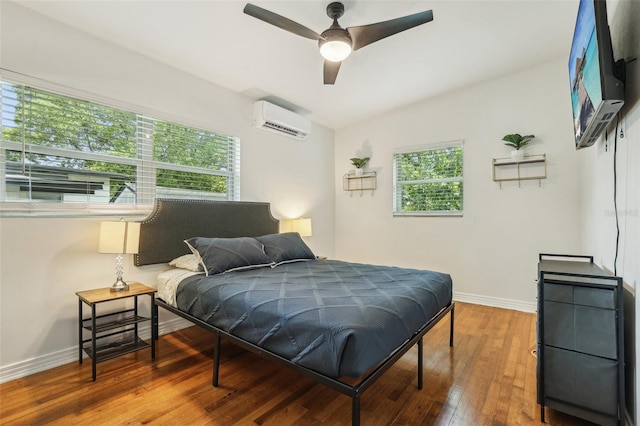 318 E Jersey St, Orlando, FL 32806 - bedroom with a wall unit AC, baseboards, hardwood / wood-style floors, and ceiling fan
